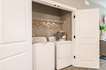 a washer and dryer in a laundry room with white doors